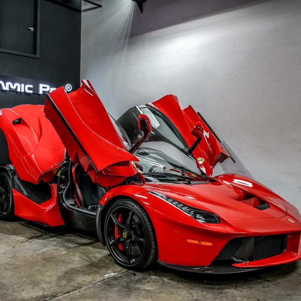Red Ferrari with glossy paint displayed indoors