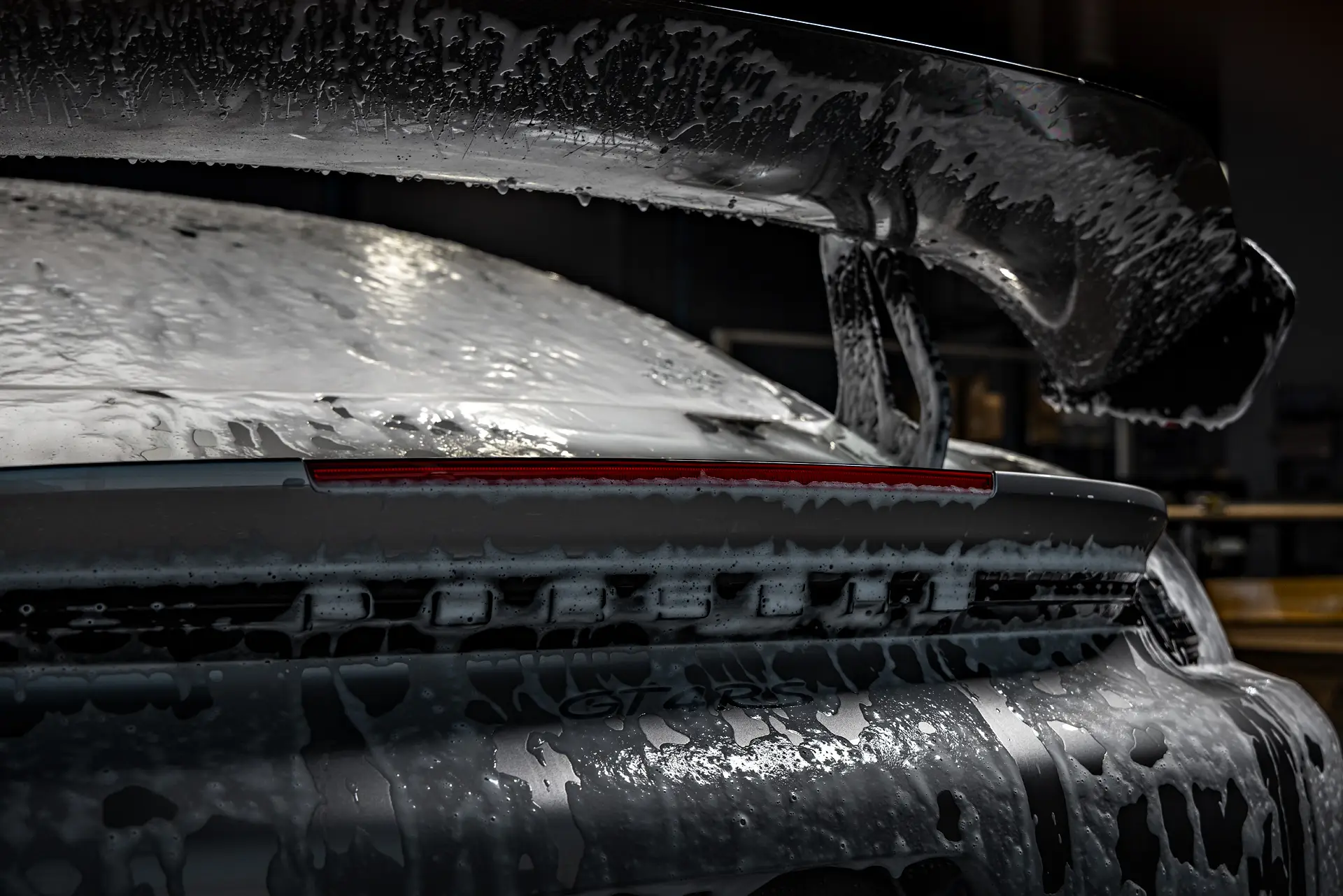 Wash foam on a Porsche rear wing
