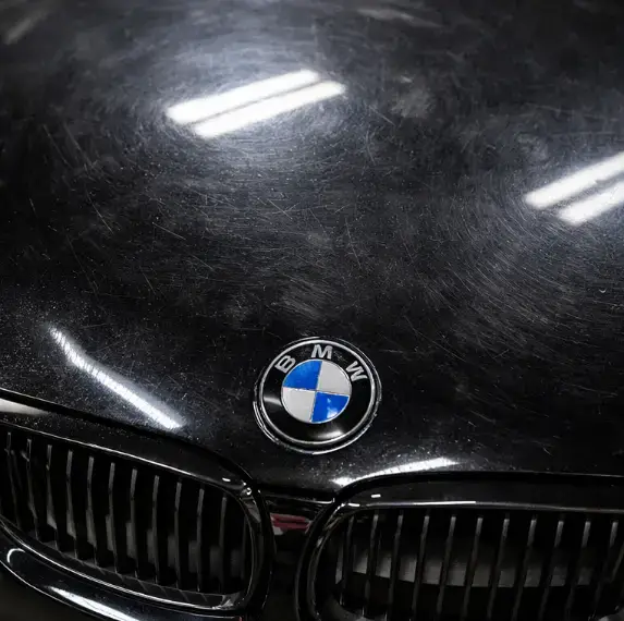 BMW hood with swirl marks before paint correction