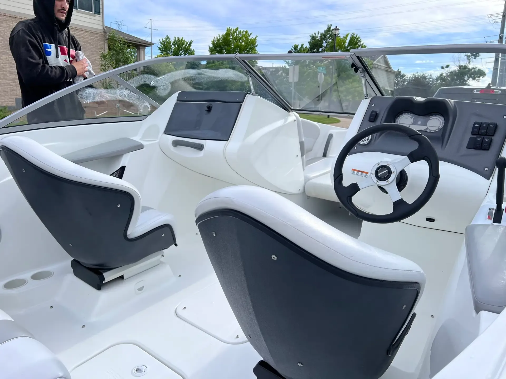 White bowrider cockpit with grey seats and helm mid-clean