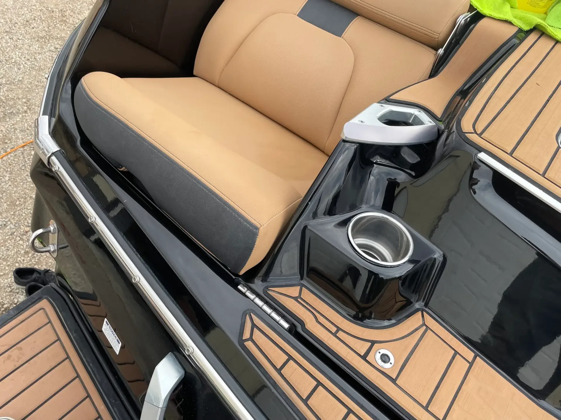 MasterCraft interior with tan seats, a cupholder console and teak-look decking