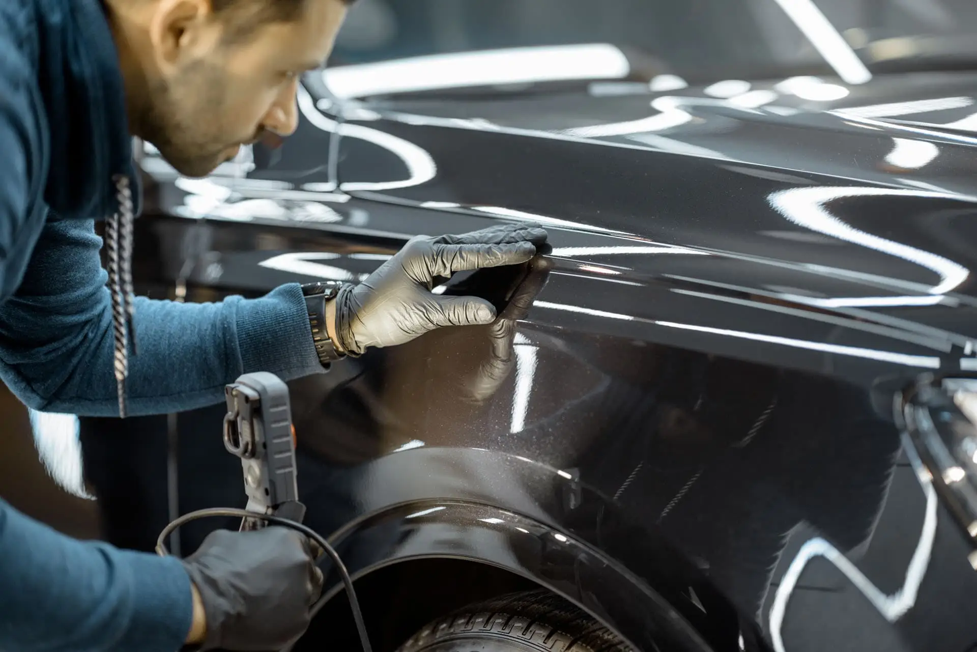 Ceramic coating inspection under lights at ST6 Detailers