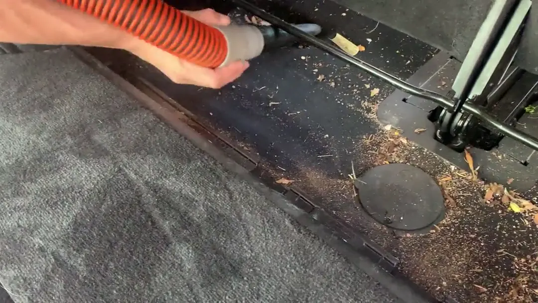 Technician vacuuming a cargo floor