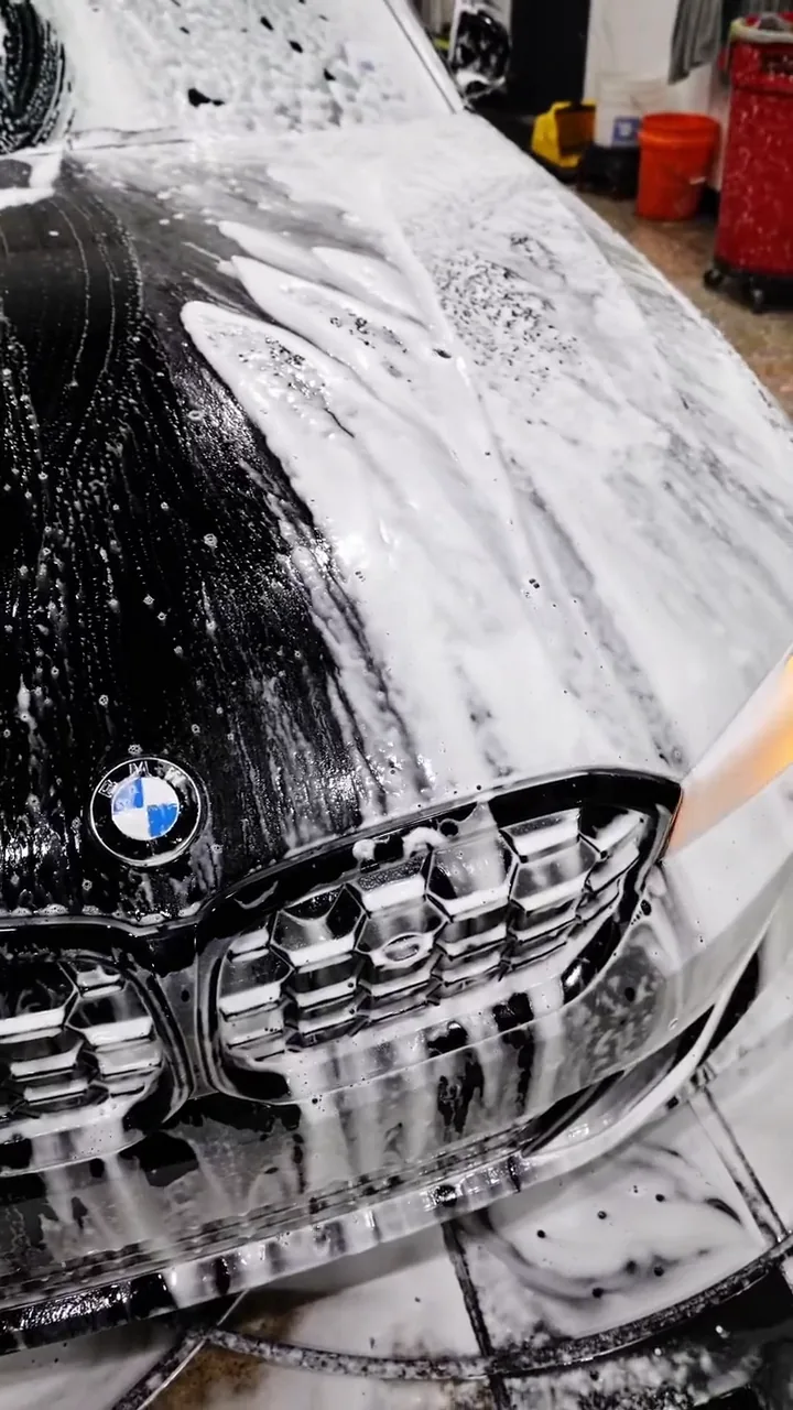 Foam pre-soak hand wash on a BMW