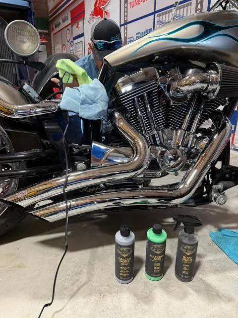 Chrome Harley-Davidson exhaust being polished by hand