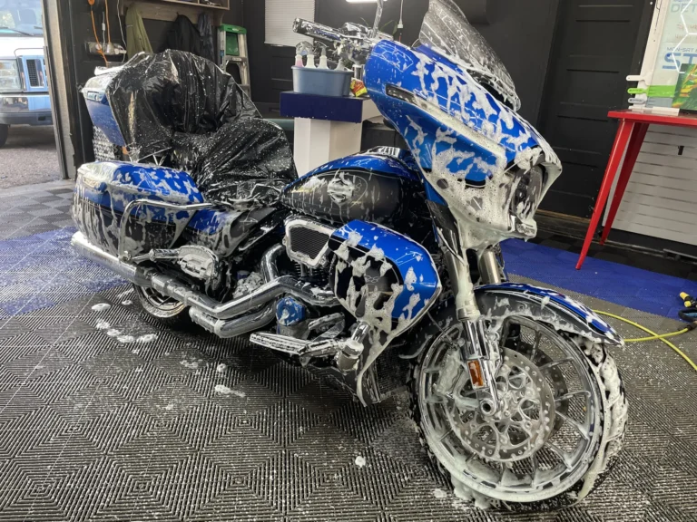 Blue Harley-Davidson CVO covered in foam during a hand wash at ST6 Detailers