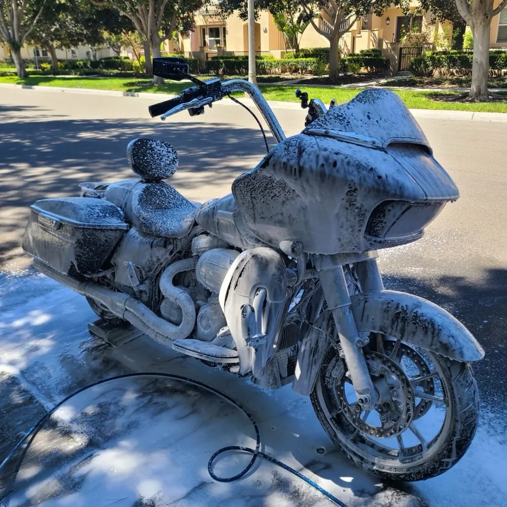 Harley-Davidson Road Glide covered in foam during an ST6 mobile motorcycle wash in a driveway