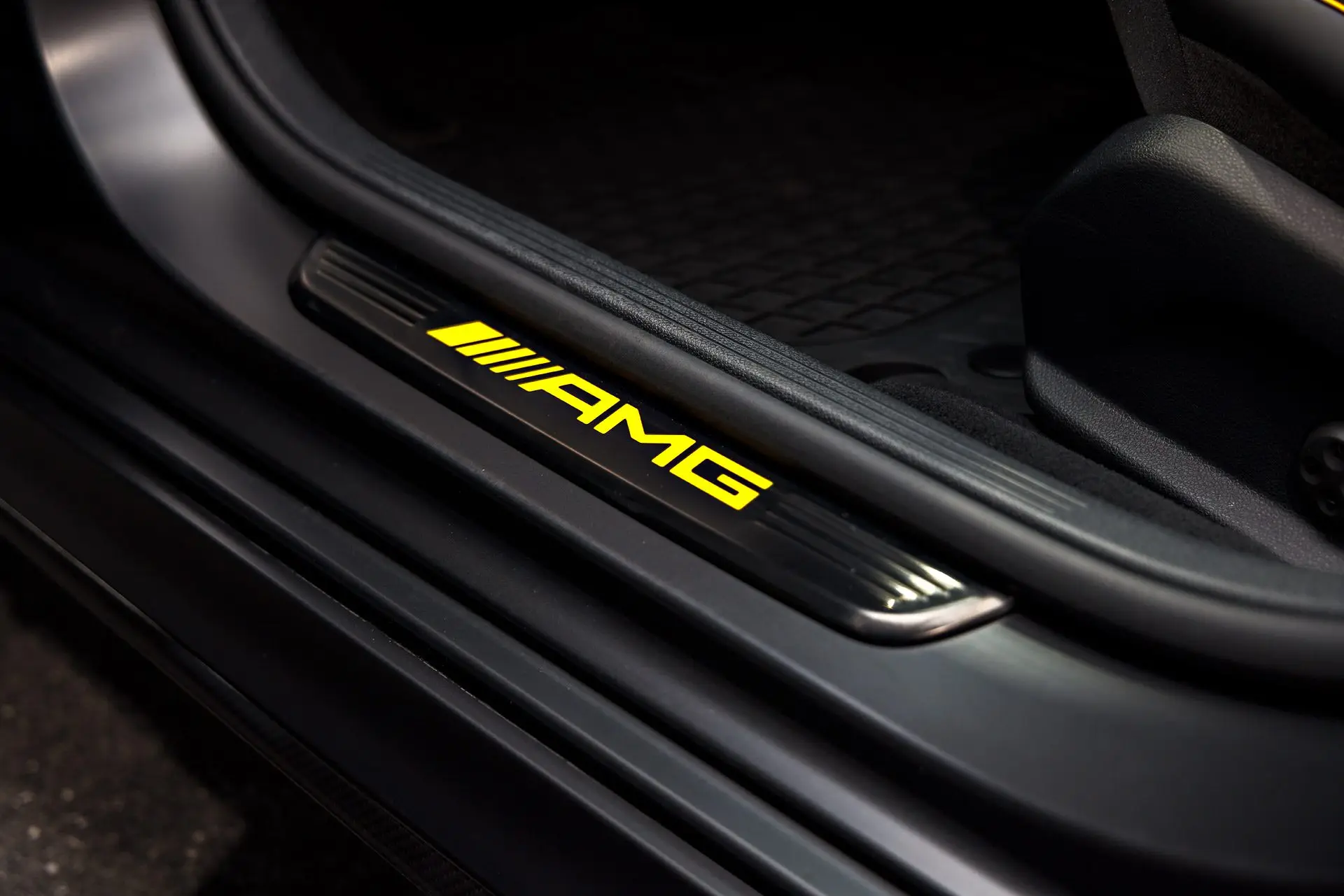Illuminated AMG door sill and clean black interior of a Mercedes-AMG after an ST6 interior detail