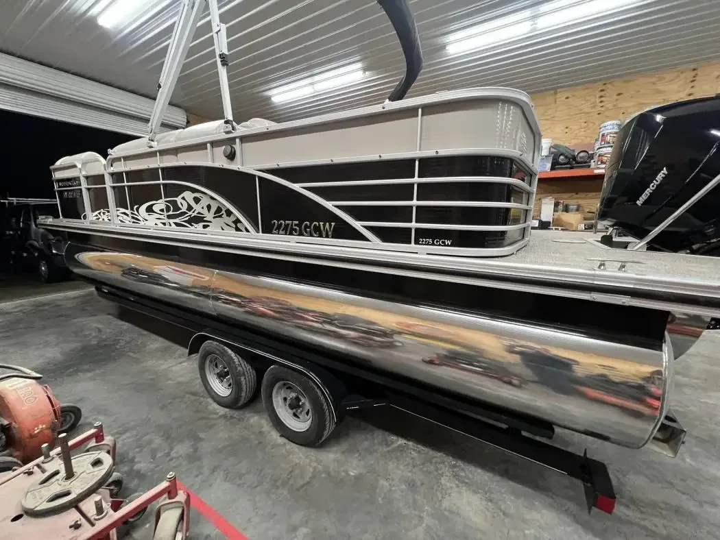 Pontoon boat on a trailer with its aluminium logs polished to a mirror finish