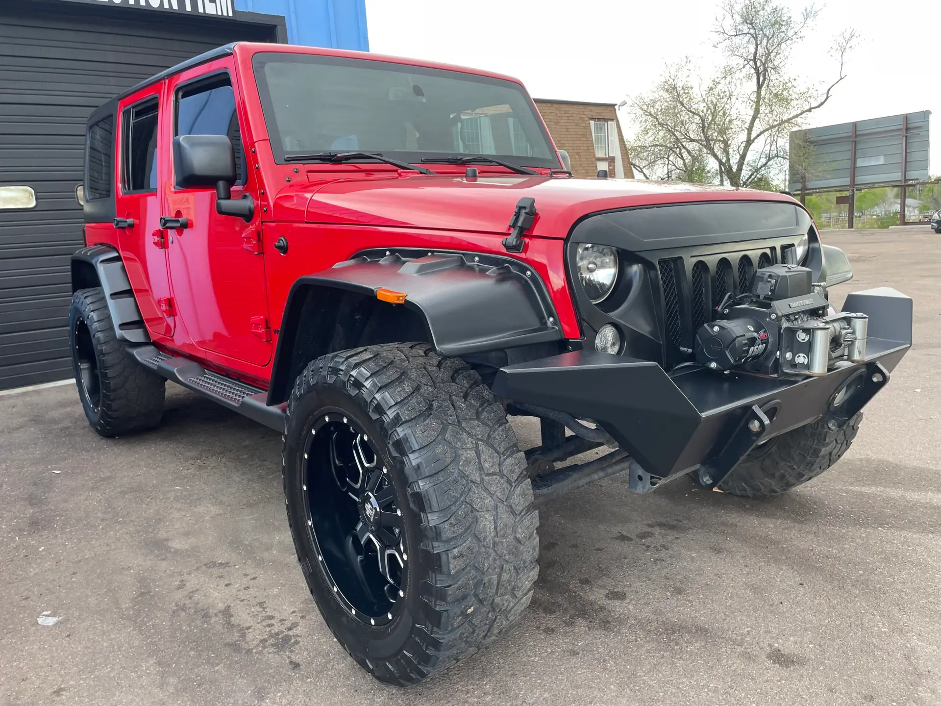 Red Jeep Wrangler with off-road bumper detailed by ST6 Detailers