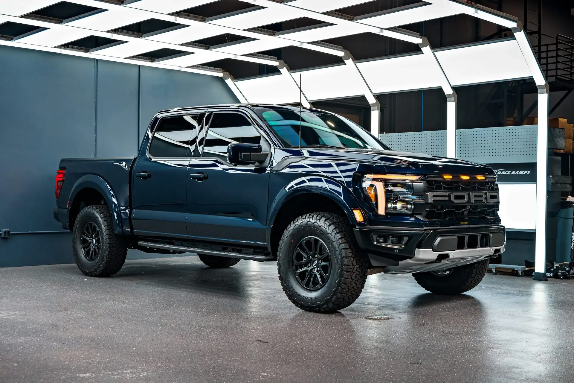 Dark blue Ford F-150 Raptor photographed side-on inside the ST6 Detailers showroom