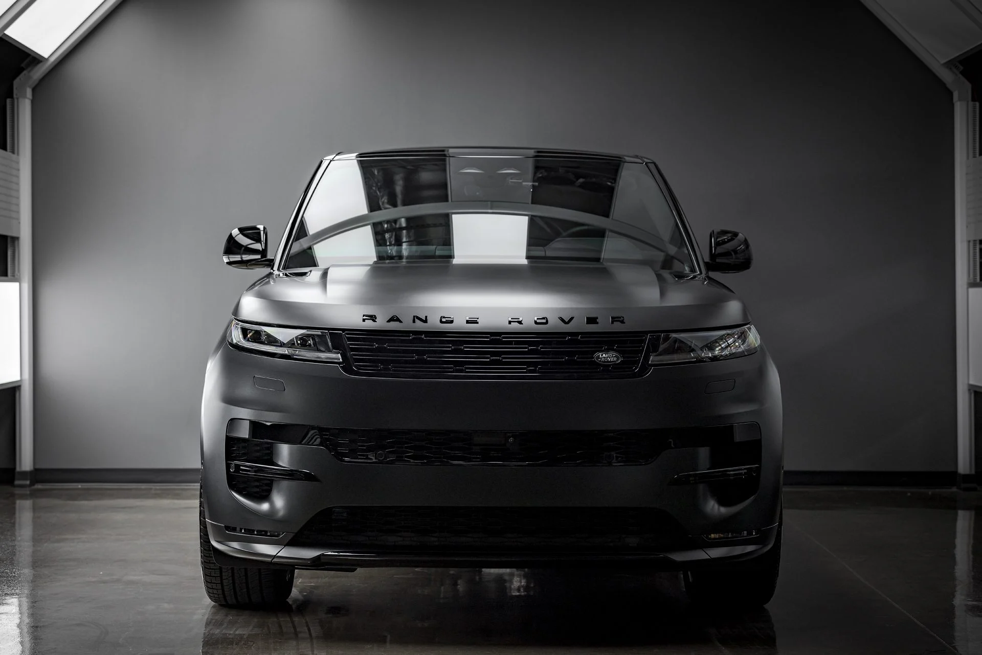 Satin black Range Rover detailed by ST6 Detailers, shot in a dark studio