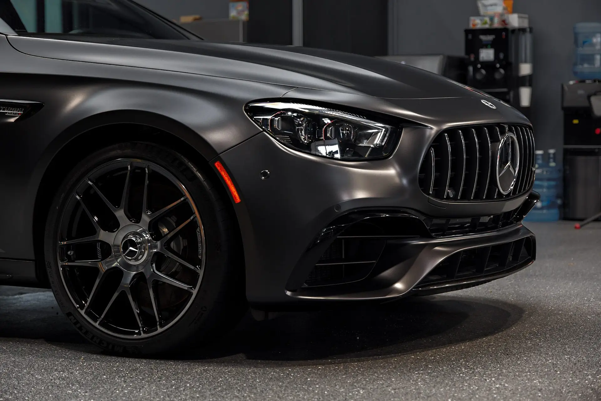 Mercedes-AMG E63 S wagon in satin dark vinyl, front three-quarter view