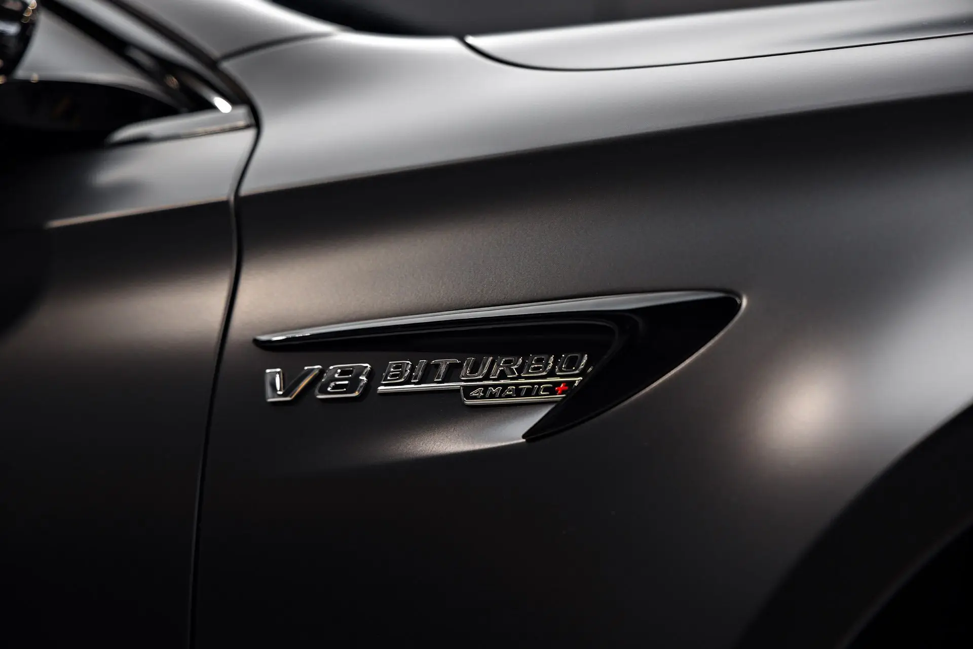 V8 Biturbo fender badge on a satin-wrapped Mercedes-AMG