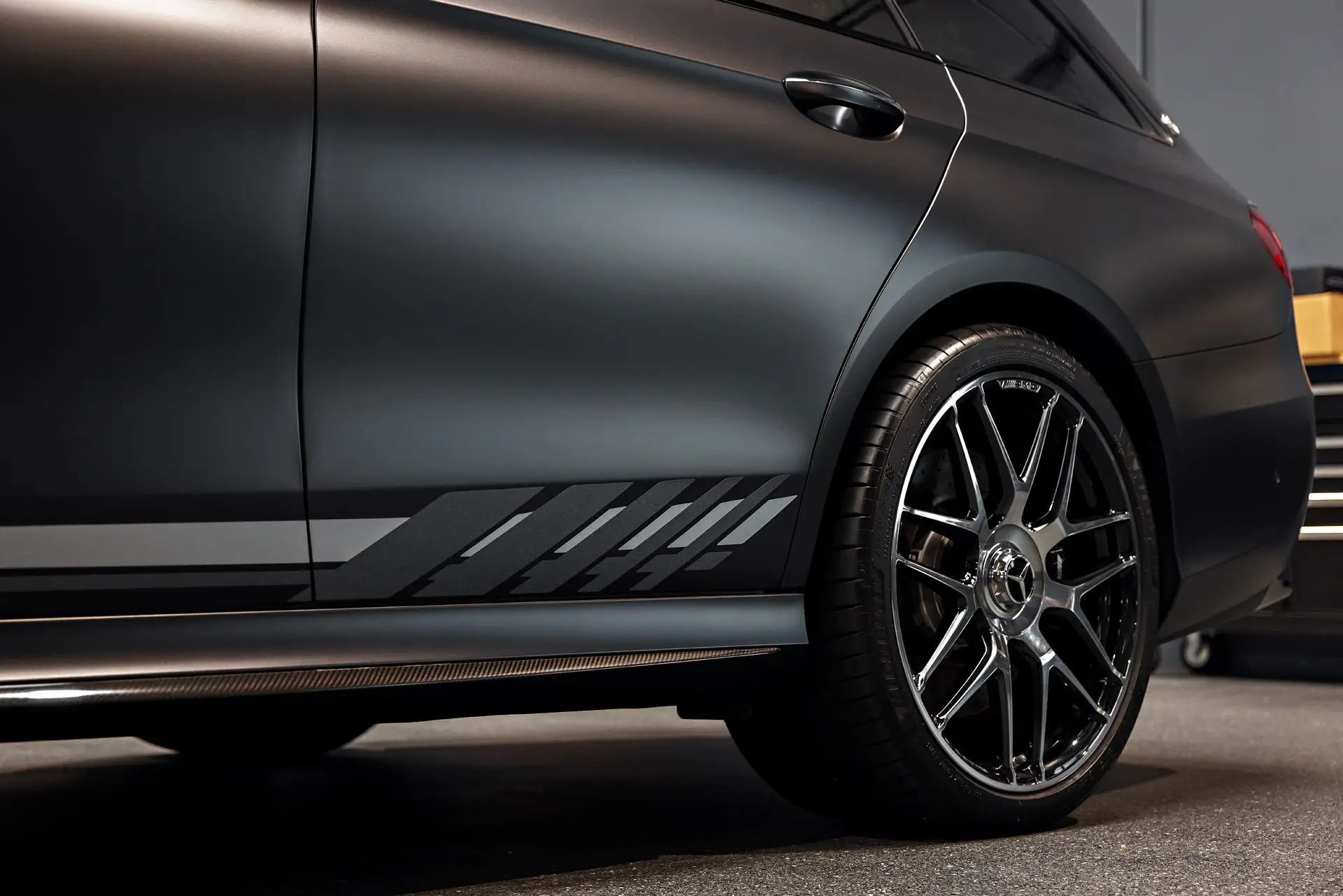 Side of a satin-wrapped Mercedes-AMG E63 S wagon with black wheels