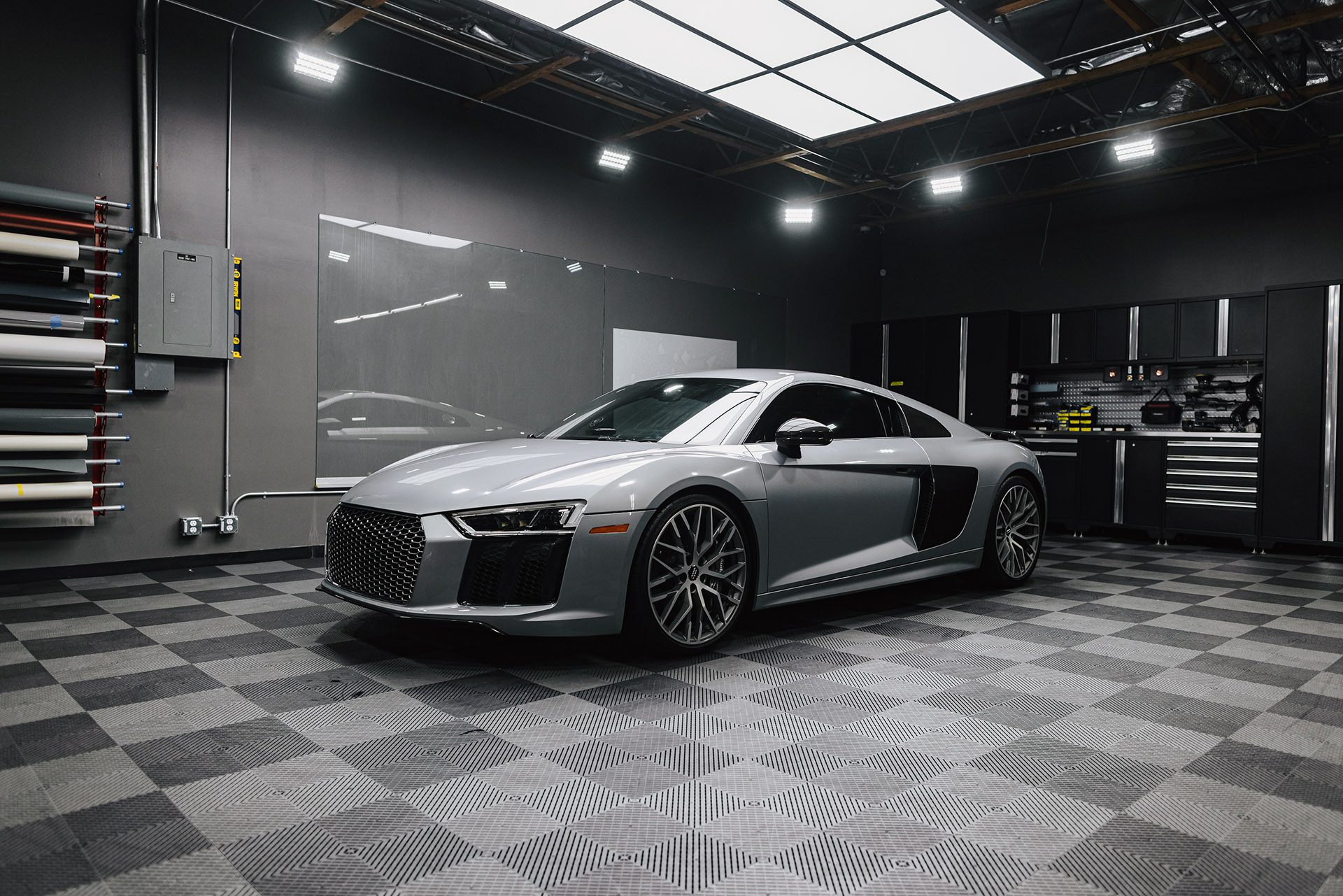 Silver Audi R8 on the checkered showroom floor
