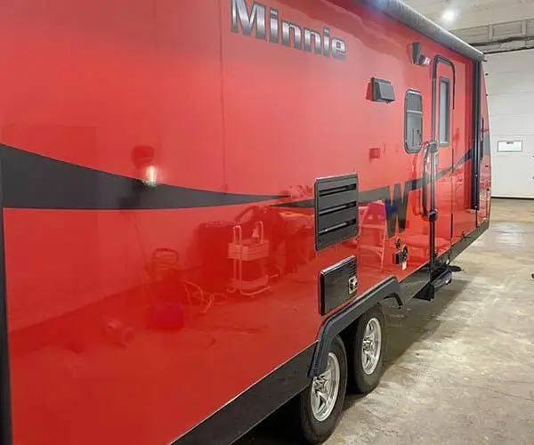 Red Minnie RV after exterior polishing with restored gloss and clearer reflections