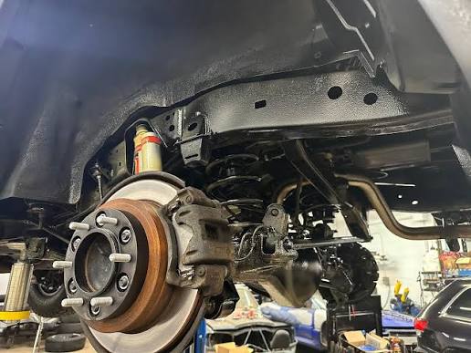 Wheel removed to expose the wheel well and suspension