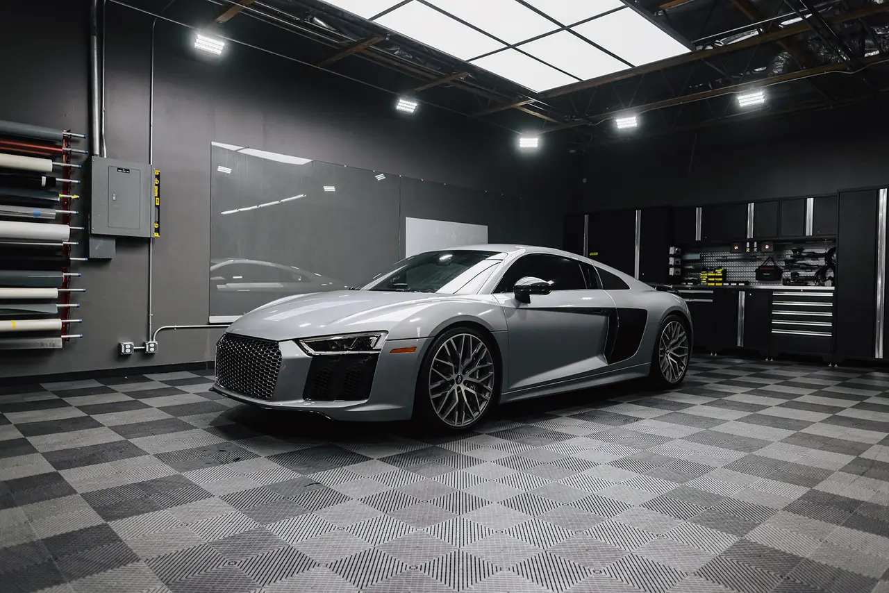 Silver Audi R8 on the checkered showroom floor