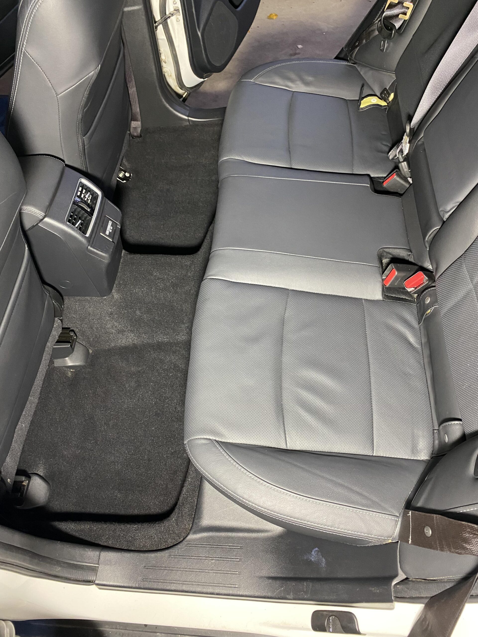 Subaru black leather rear seats, carpet and floor mats after interior cleaning