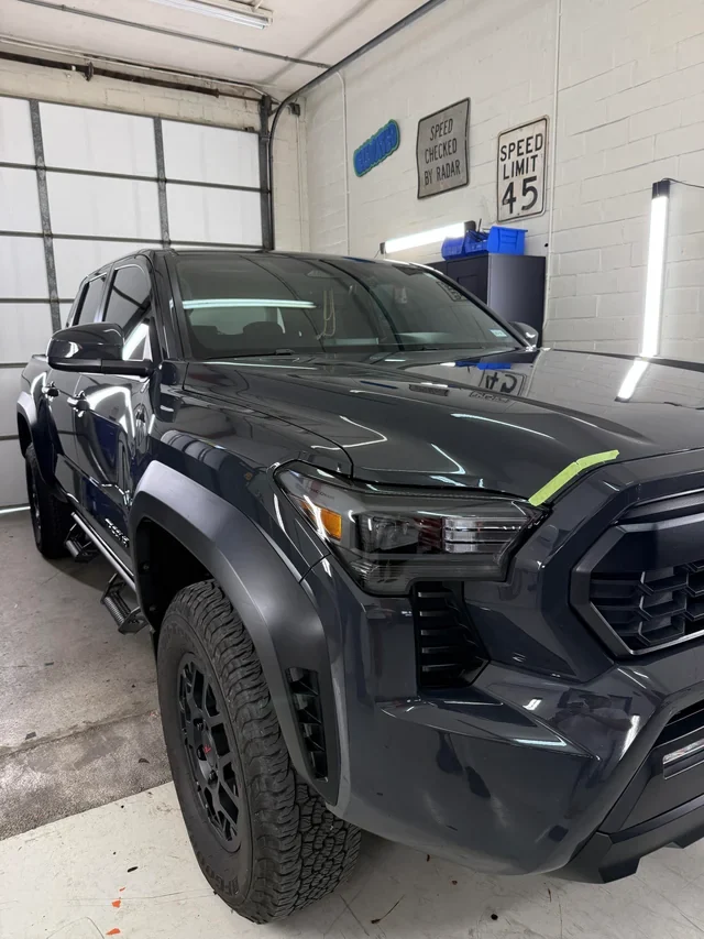 Toyota Tacoma under inspection lights for paint correction in Colorado Springs