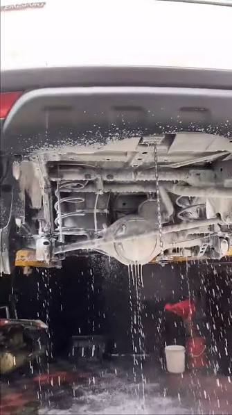 Underbody covered in cleaning solution during preparation