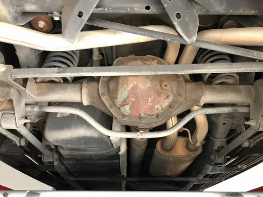 Surface rust on the rear axle housing and adjacent underbody components