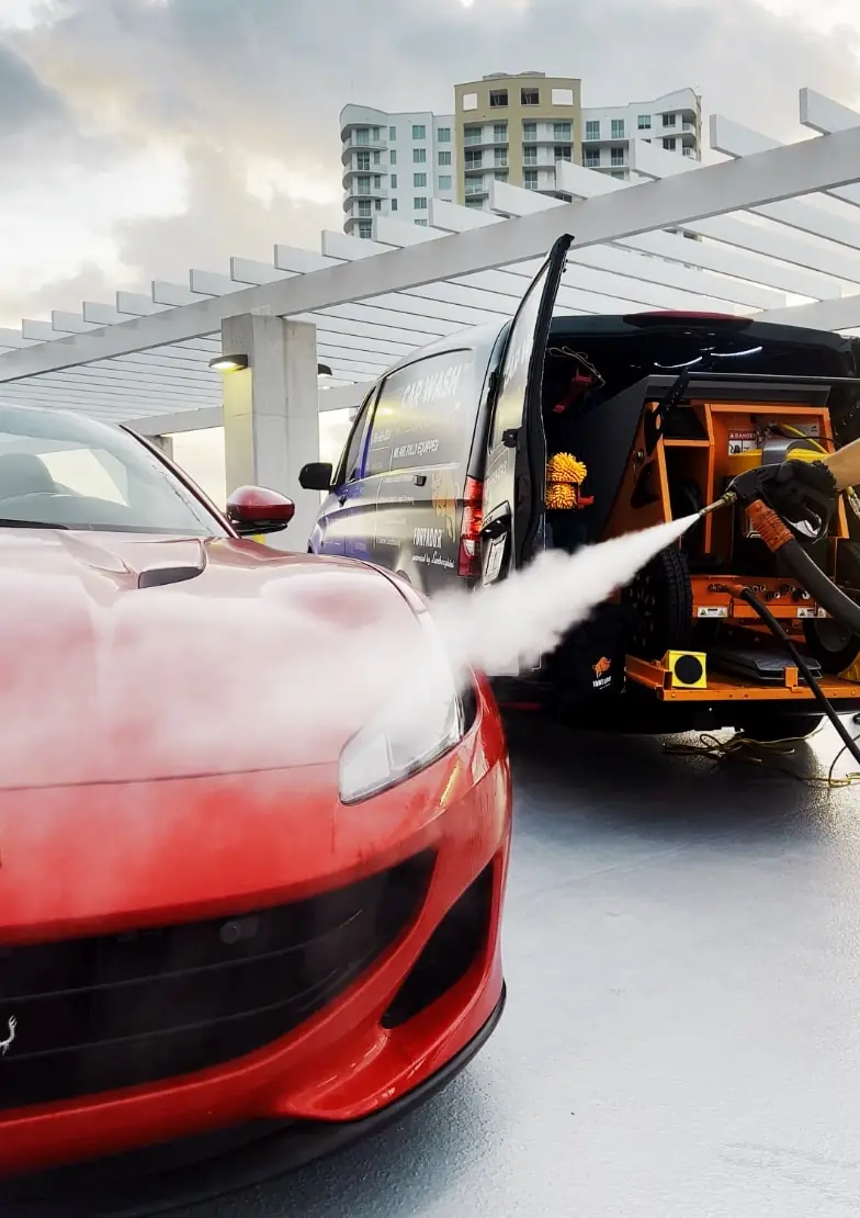 Red Ferrari pressure washed beside an ST6 mobile unit